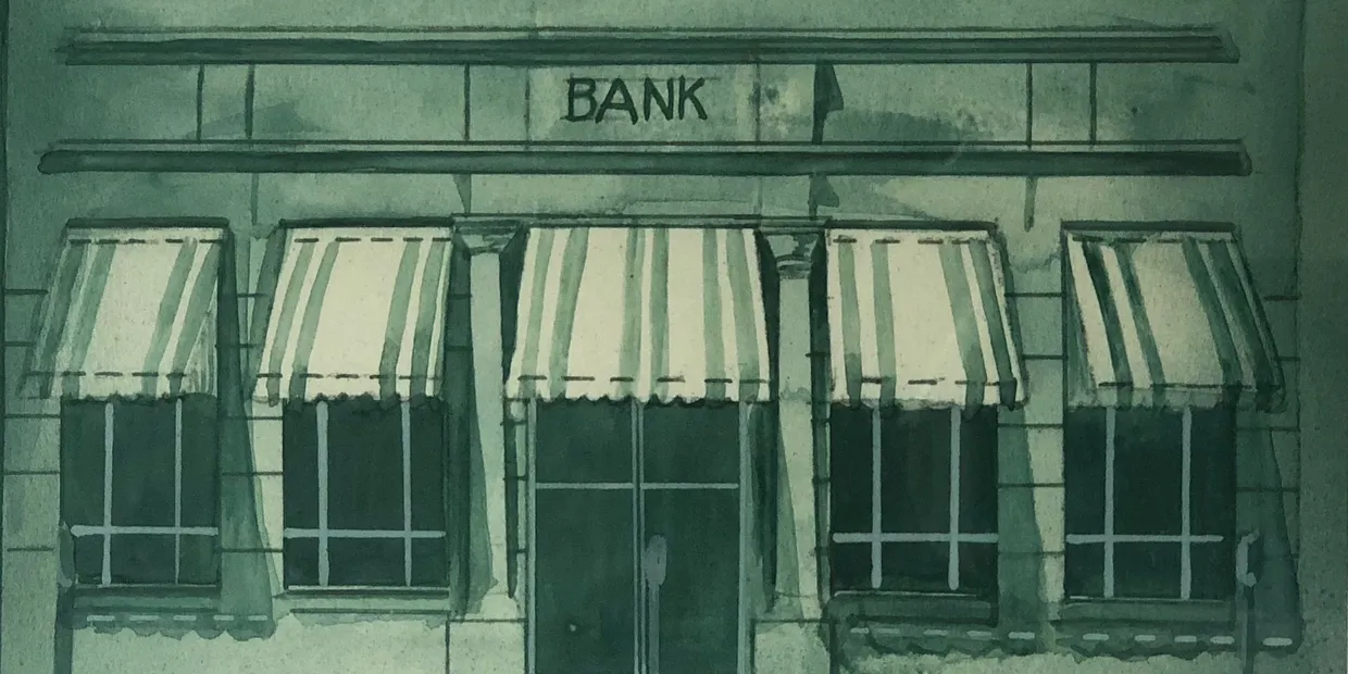 6838b2706fa1c_cr=w_1240,h_620 Old bank building facade with striped awnings.